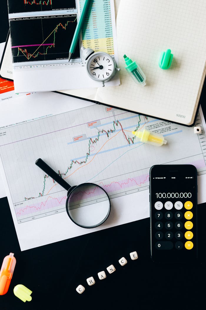 services-01 Stock market analysis setup with graphs, calculator, and magnifying glass.